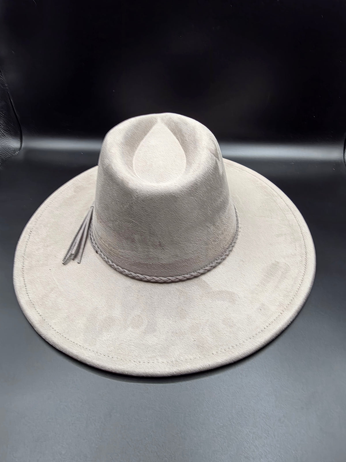 Gray wide-brimmed hat on a dark background